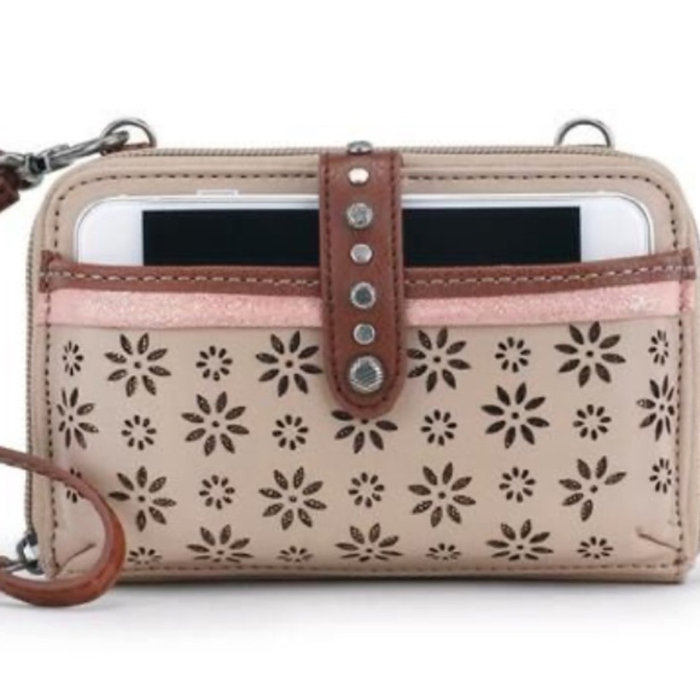 The Sak Beige Floral Laser-Cut Wristlet with Brown Trim and Pink Accent